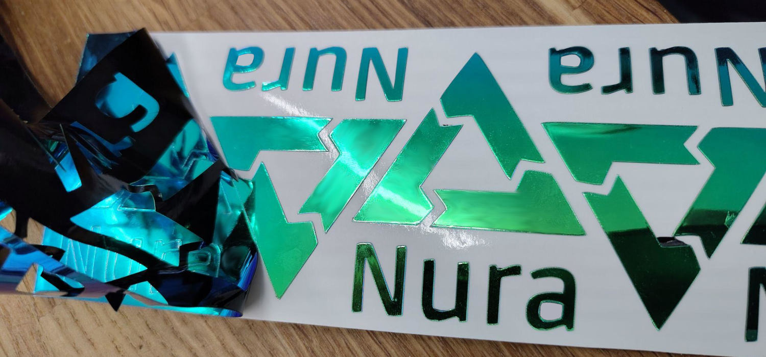 Ряд наклеек Nura в процессе производства